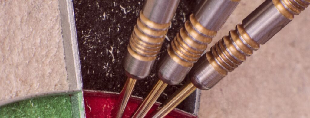 3 tungsten darts in dartboard